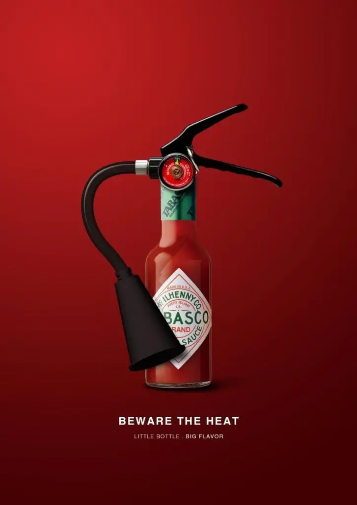 Tabasco bottle designed as a fire extinguisher with text "Beware the Heat: Little Bottle, Big Flavor."